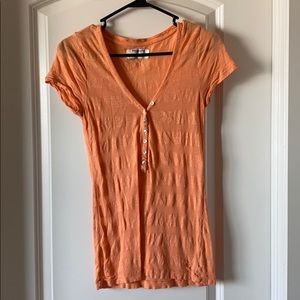 Women’s orange striped American Eagle shirt.